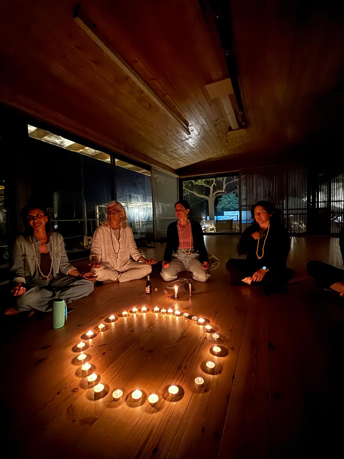 Evening meditation circle with candles arranged in a heart shape