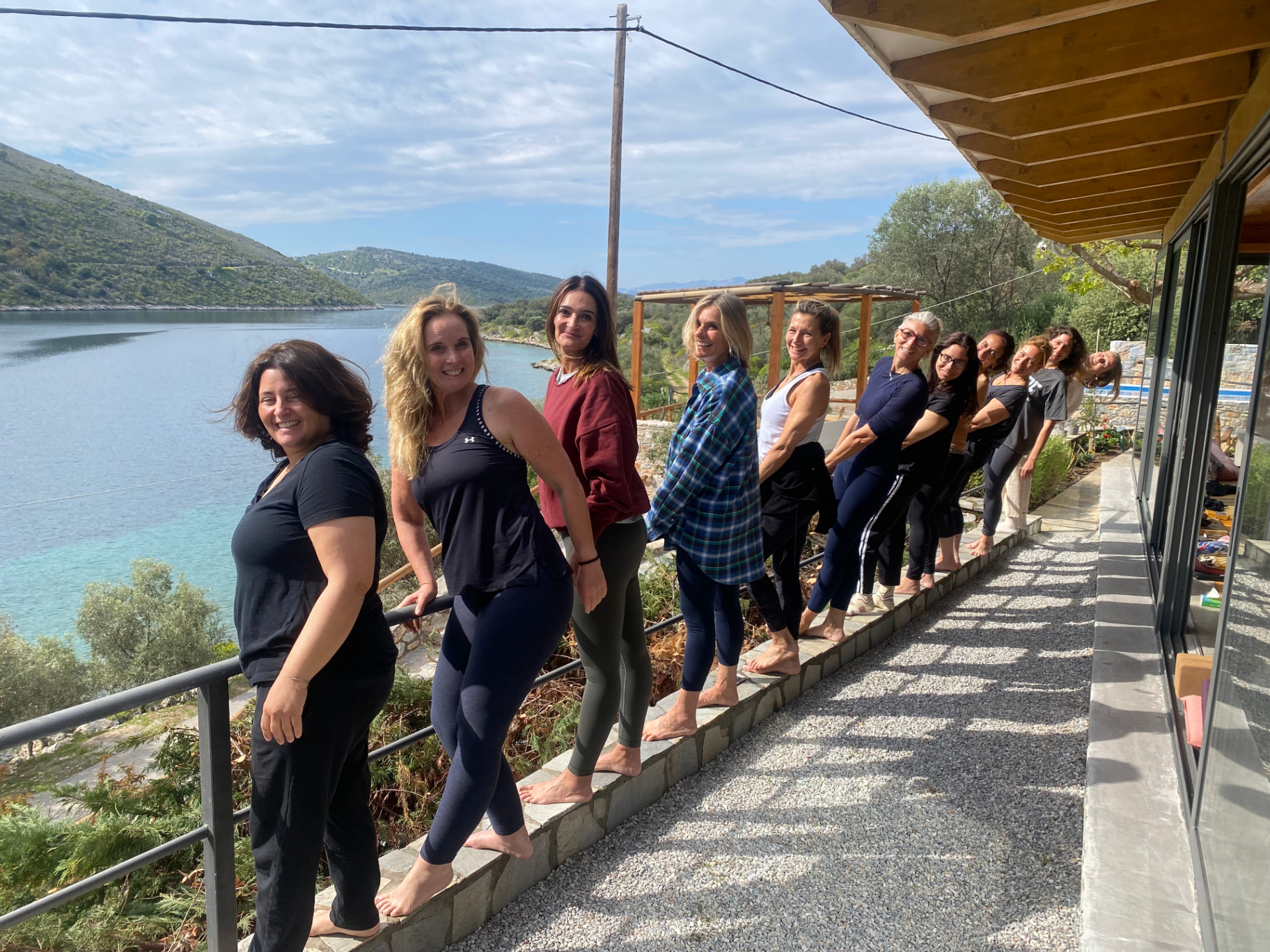 Group of participants smiling by the sea